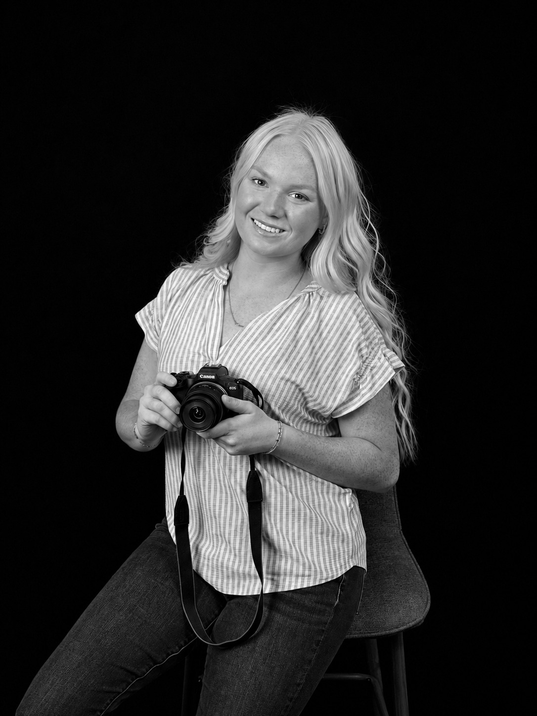 Madelyn holding her camera, in black and white