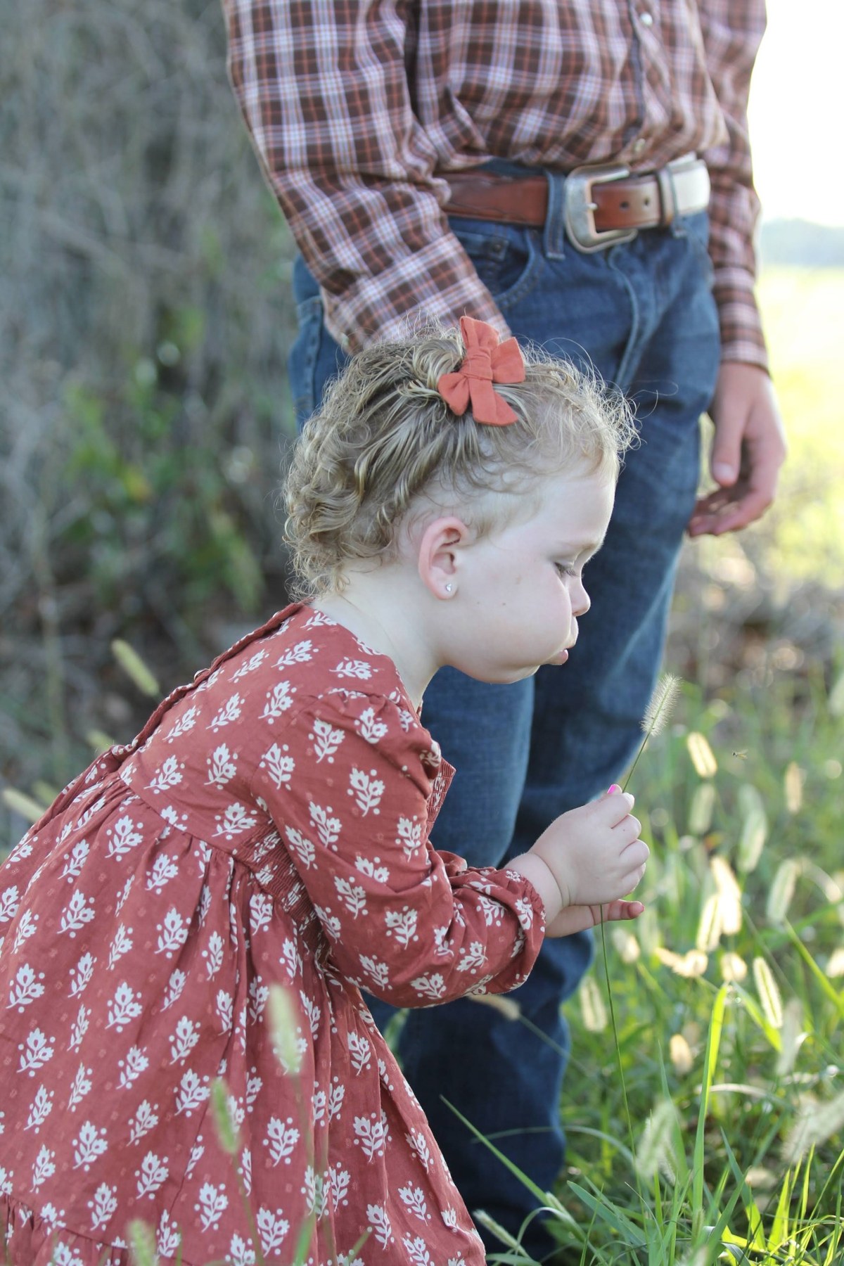Child outdoors with family