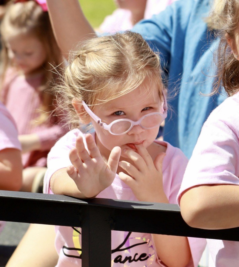 Young dancer waving at a parade